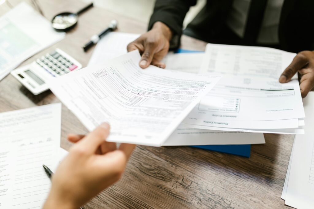 A person being handed documents signifying a lending process